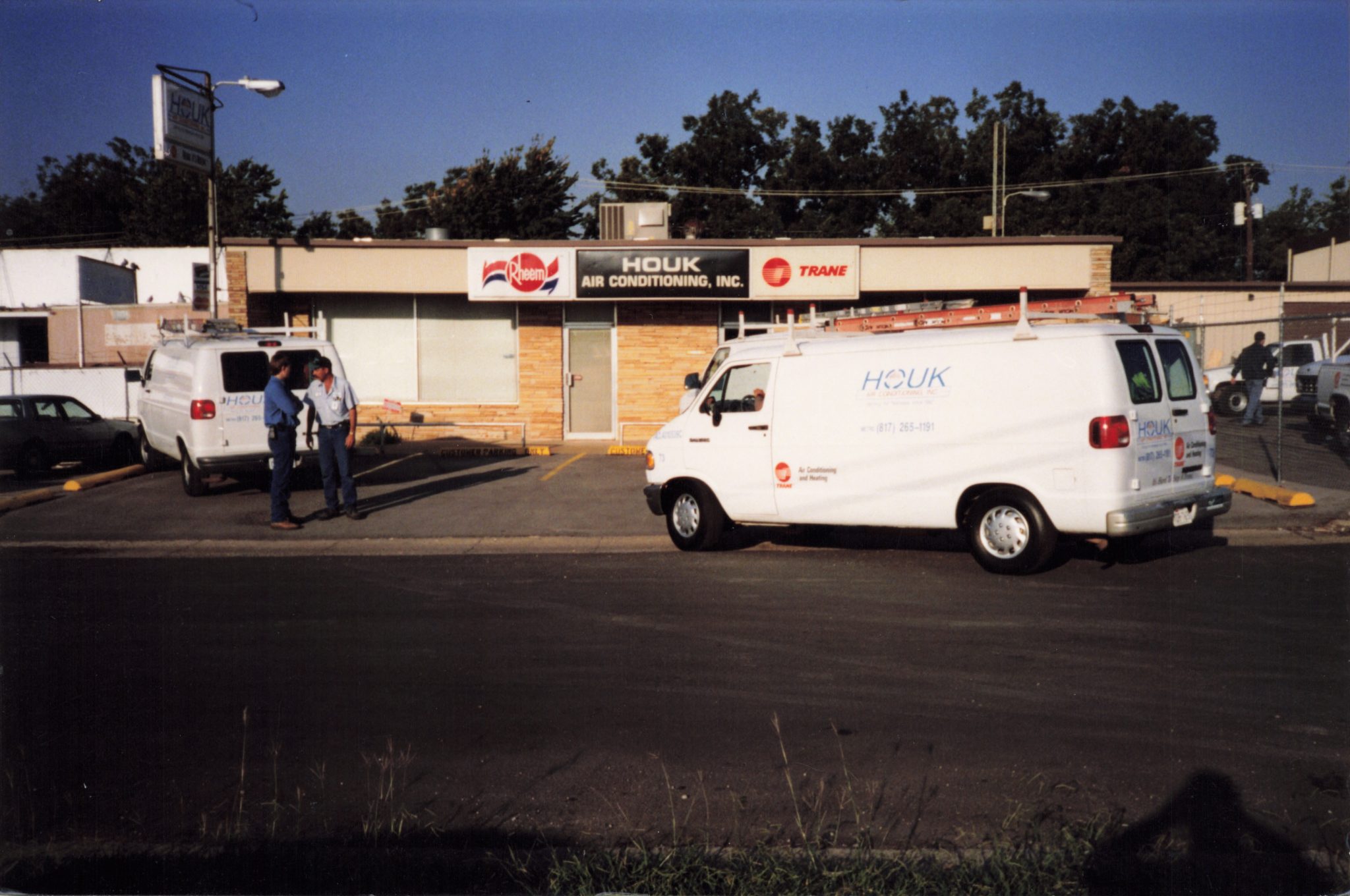 Houk AC service vans parked outside the company’s historic air conditioning office in North Texas.
