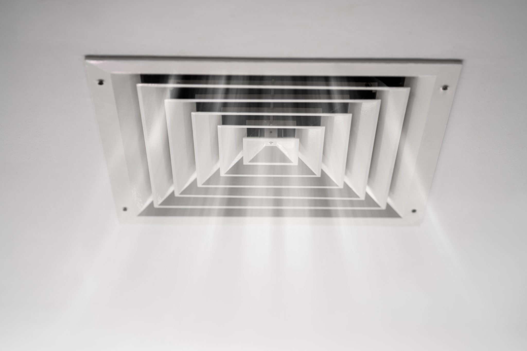 Indoor air vent circulating air through an HVAC system during indoor allergies in spring.